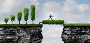 Unleashing the power of emergent change is illustrated by a man crossing a chasm using a tree that he has just chopped down. the axe is still in his hand.